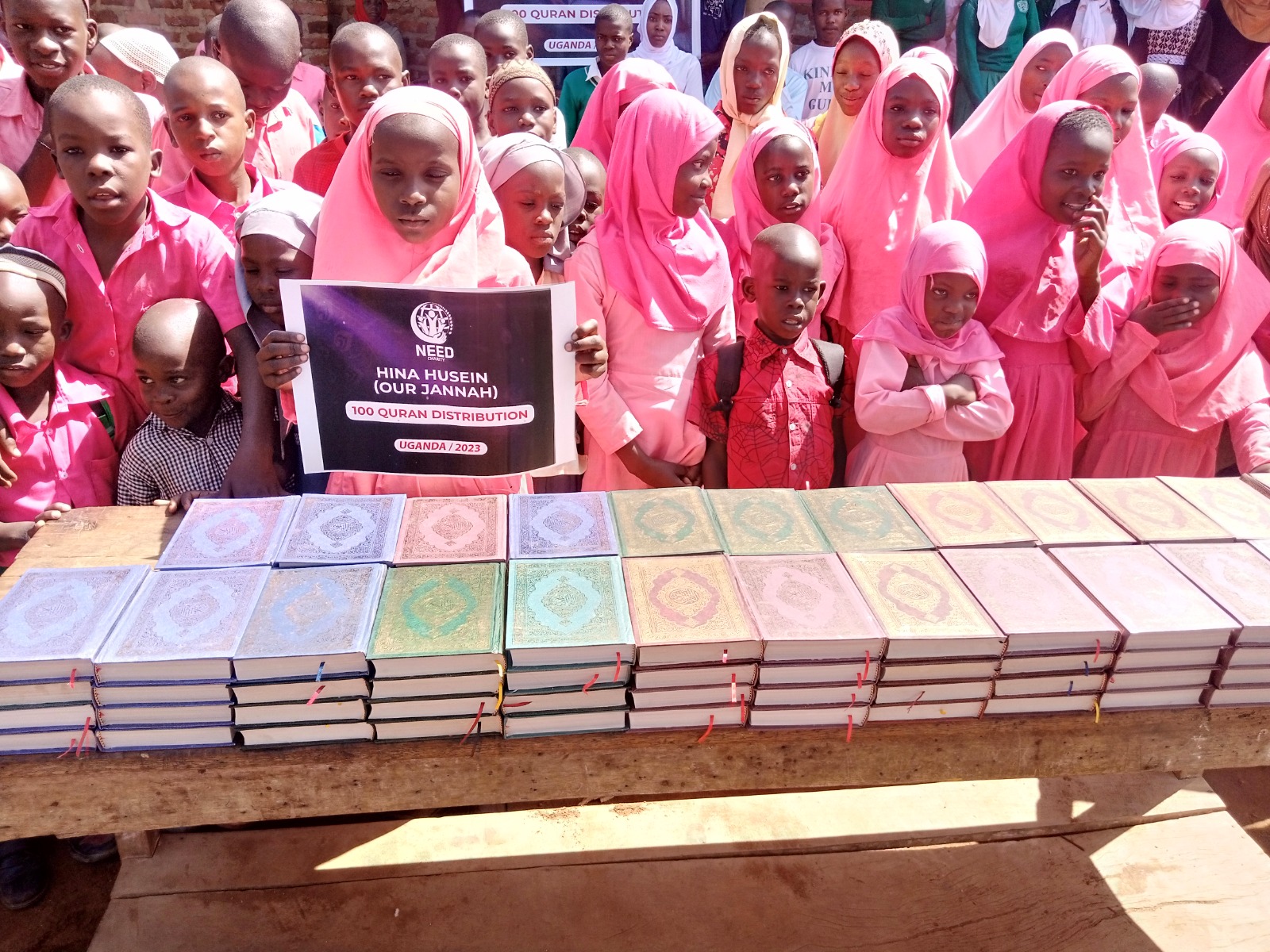 Students and community members at a Quran distribution event